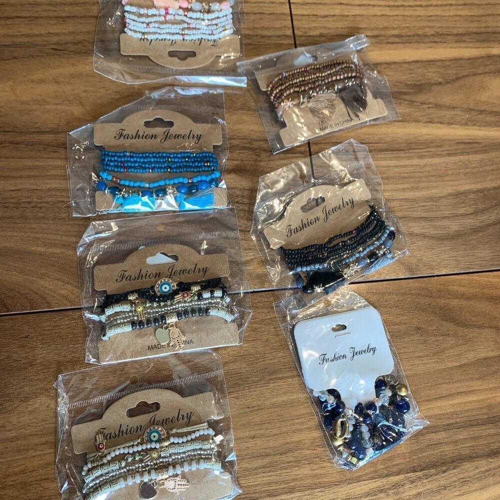 New, bundle of 3 packs of 6 strands each, beads and charms on stretch chord